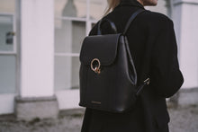 Load image into Gallery viewer, A Lady walking with a black leather backpack from Cocoona
